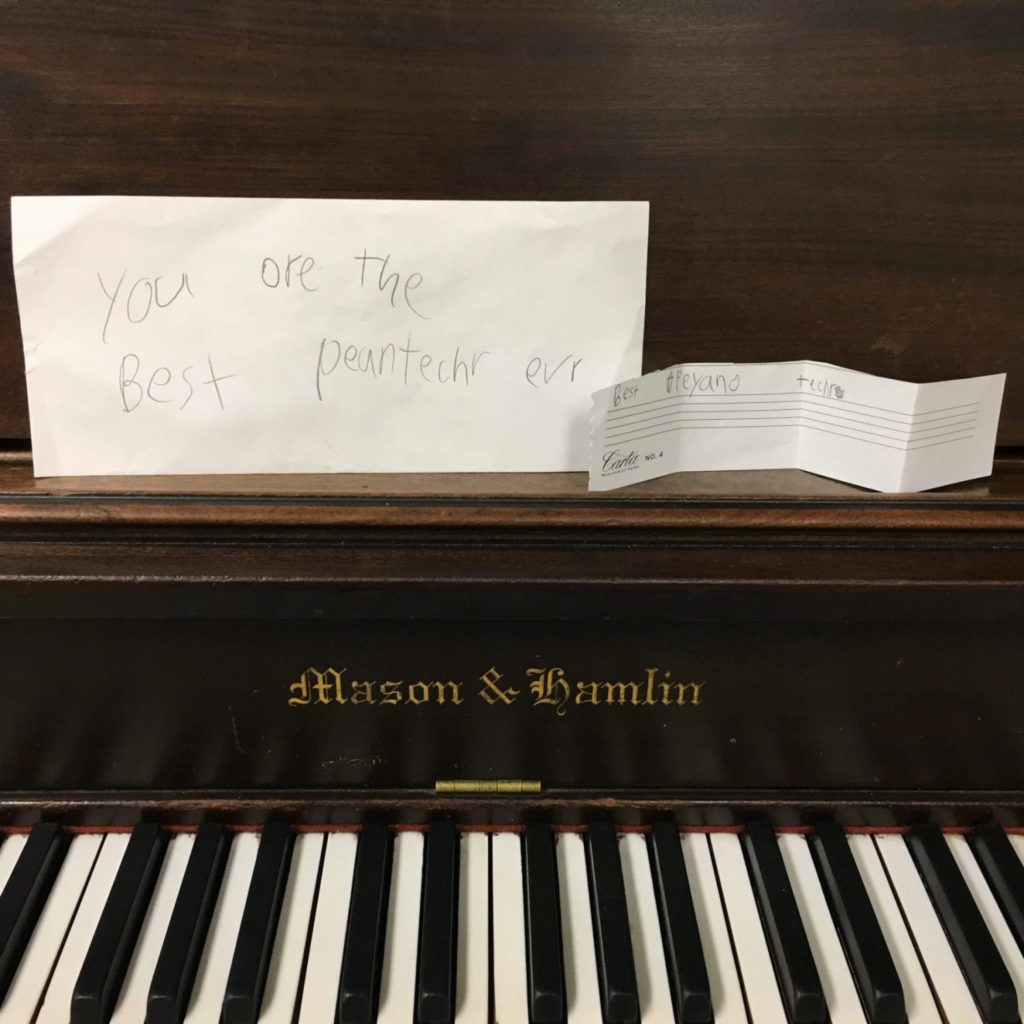 Mason Hamlin acoustic upright piano with a young child's handwriting saying you are the best piano teacher ever